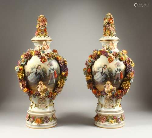 A PAIR OF MEISSEN STYLE VASES, COVERS AND STANDS, with cherubs, floral garlands and panels decorated