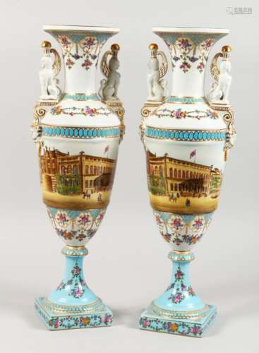 A PAIR OF SEVRES STYLE CLASSICAL TWIN-HANDLED PEDESTAL VASES, decorated with street scenes. 19ins