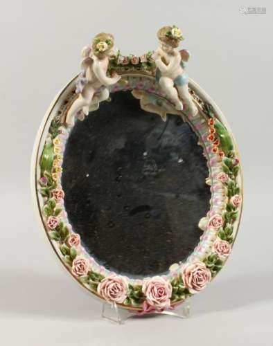 A MEISSEN STYLE OVAL WALL MIRROR, encrusted with cherubs and flowers. 12ins high.