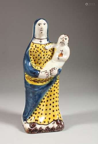 A 19TH CENTURY CONTINENTAL FAIENCE POTTERY MODEL OF A MADONNA AND CHILD. 8.5ins high.