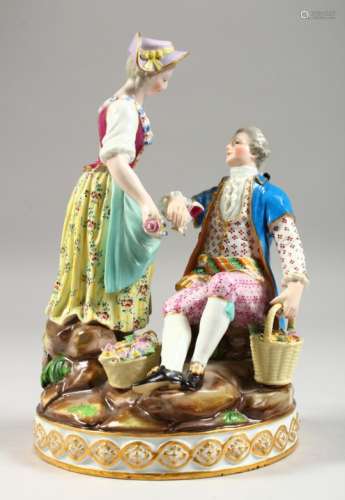 A MEISSEN GROUP OF A GENTLEMAN SEATED WITH A BASKET IN ONE HAND, a lady by his side with a bottle in