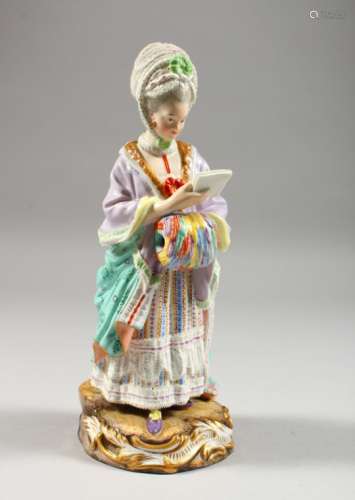 A MEISSEN FIGURE OF A LADY, standing with book in one hand, her other hand in a muff, crossed