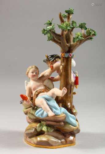 A GOOD MEISSEN GROUP OF TWO CHERUBS, seated beneath a tree working at a grindstone, crossed swords