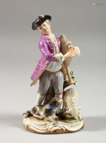 A SMALL MEISSEN FIGURE OF A MAN PLAYING BAGPIPES, a dog and sheep at his feet, cross swords mark