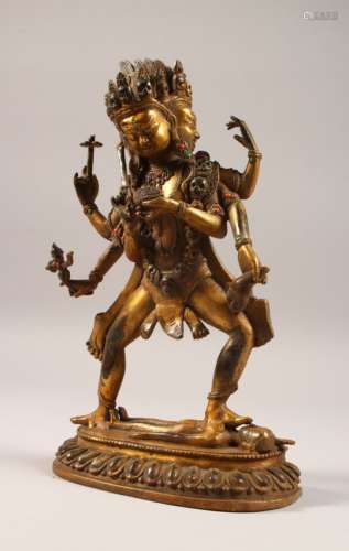 A GILT BRONZE MULTI-ARM GOD, inset with coral and turquoise stones. 11.5ins high.