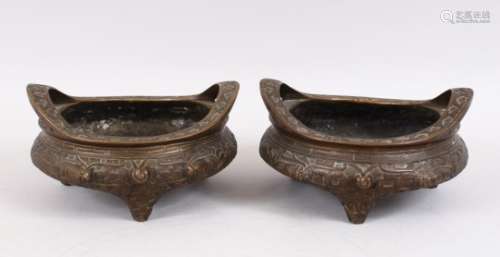 TWO GOOD CHINESE BRONZE TRIPOD CENSERS, Both with deep carved scenes of chilongs and archaic design,