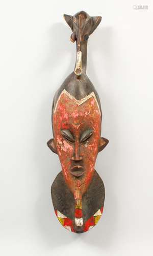 A CARVED AND PAINTED TRIBAL MASK, with elephant head finial. 25ins high.