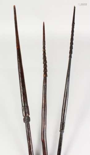 THREE PAPUA NEW GUINEA CARVED BARBED SPEARS, undecorated. Longest: 8ft 9ins (3).