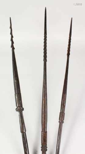 THREE PAPUA NEW GUINEA CARVED BARBED SPEARS, undecorated. Longest: 8ft 9ins (3).