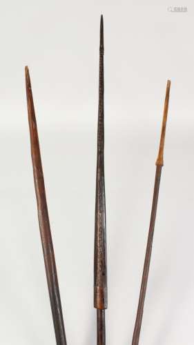 THREE PAPUA NEW GUINEA CARVED BARBED SPEARS. Longest: 8ft 3ins (3).