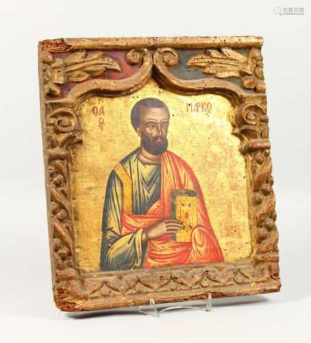 A 19TH CENTURY RUSSIAN ICON, depicting a saint, in a carved border, old Sotheby's label verso. 15ins