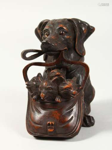 A BLACK FOREST STYLE CARVED WOOD INKWELL, modelled as a dog holding a bag of puppies in its mouth.