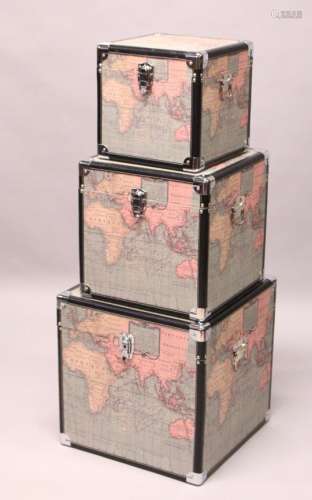 A SET OF THREE SQUARE TRUNKS, printed with maps of the world. Largest: 1ft 6ins wide.