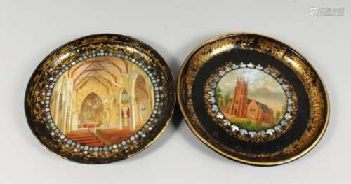TWO VICTORIAN CIRCULAR PAPIER MACHE TRAYS, decorated with a church exterior and interior. 12ins