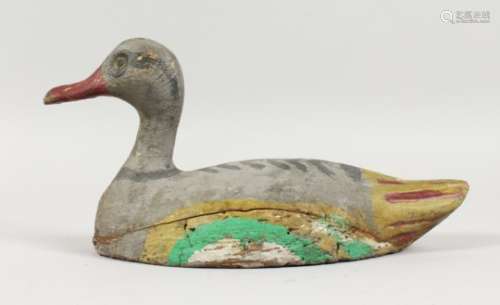 A CARVED AND PAINTED DUCK DECOY. 11ins long.