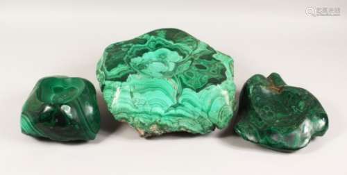 A LARGE NATURALISTIC PIECE OF MALACHITE, partially carved to form a dish, and two similar pieces (