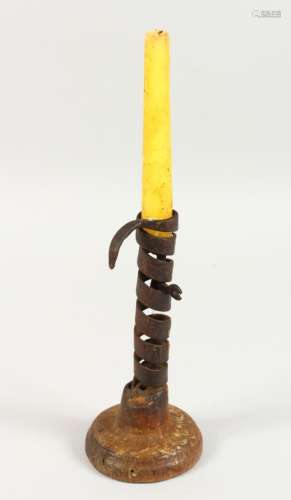 AN EARLY IRON CANDLESTICK, on turned wood base. 7.5ins high.