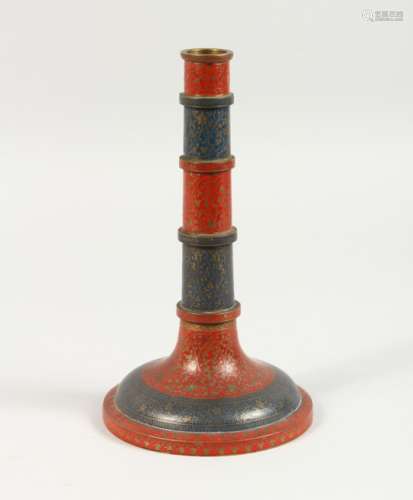 AN ISLAMIC ENAMEL DECORATED CANDLESTICK. 9ins high.