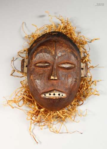 A CARVED WOOD TRIBAL MASK 