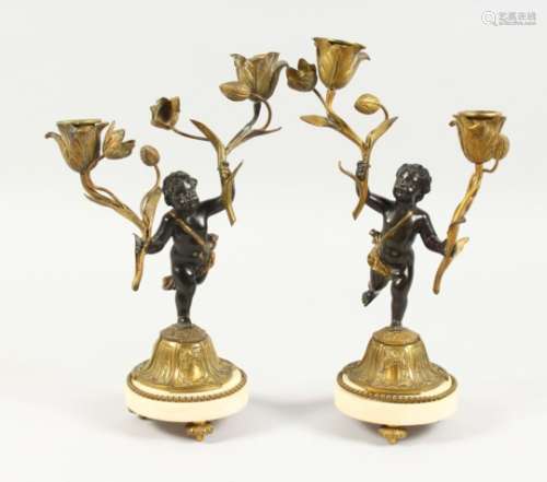A GOOD PAIR OF 19TH CENTURY FRENCH BRONZE AND ORMOLU TWO-LIGHT CANDLESTICKS, on circular marble