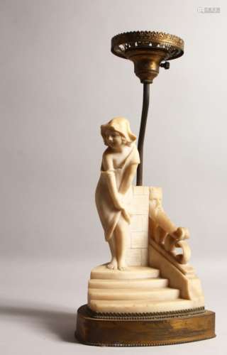 AN ALABASTER TABLE LAMP, modelled as a young girl stood on a flight of steps. 18ins high including