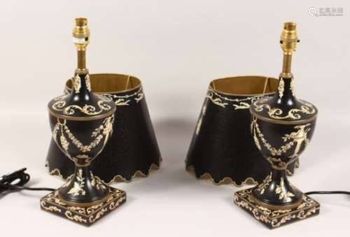A PAIR OF BLACK TOLEWARE STYLE URN SHAPED TABLE LAMPS AND SHADES. 21ins high.