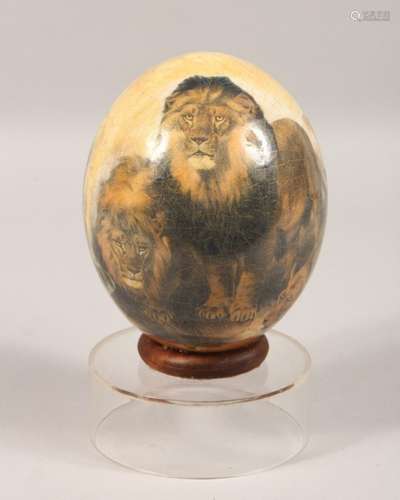 AN OSTRICH EGG, decorated with lions and leopards, on a Perspex stand. 8.5ins high.