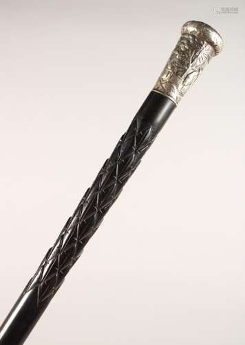 A CARVED EBONY WALKING STICK, with embossed Chinese white metal top. 34ins long.