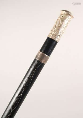 A BLACK LEATHER COVERED WALKING STICK, with eastern white metal mounts. 36ins long.