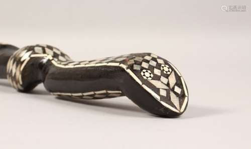 AN EBONISED CARVED WOOD SNAKE SHAPED WALKING STICK, with mother-of-pearl inlay. 36.5ins long.