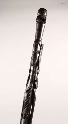 AN AFRICAN CARVED WOOD FIGURAL WALKING STICK. 34.5ins long.