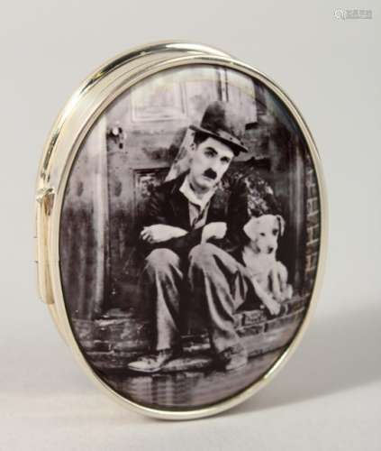 A SILVER OVAL PILL BOX, the lid with an enamel of Charlie Chaplin.