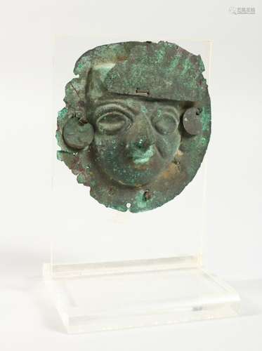 A SOUTH AMERICAN PATINATED COPPER MASK, on Perspex stand.