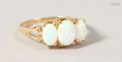 A 9CT GOLD THREE STONE OPAL RING.