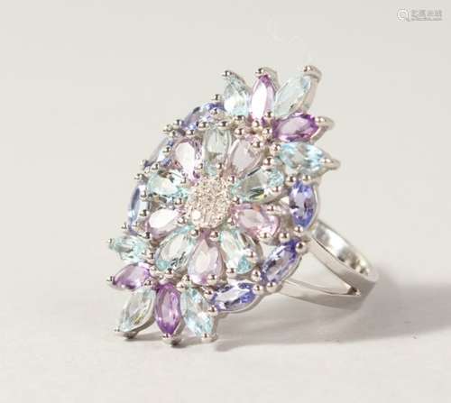 A SILVER, AMETHYST AND BLUE TOPAZ DRESS RING.