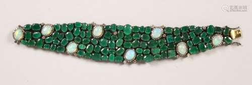 A HIGHLY DECORATIVE EMERALD AND MOONSTONE OPENWORK BRACELET. 7ins long.