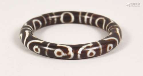 A TIBETAN STYLE HARDSTONE BANGLE. 3ins diameter.