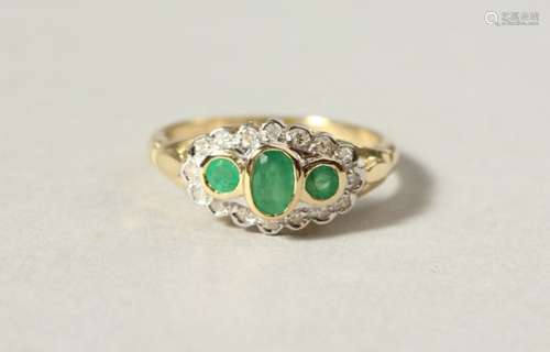 A 9CT GOLD, EMERALD AND DIAMOND RING.