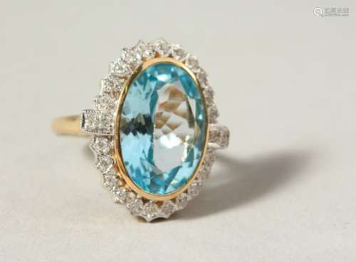 A 9CT GOLD LARGE BLUE TOPAZ AND DIAMOND RING.