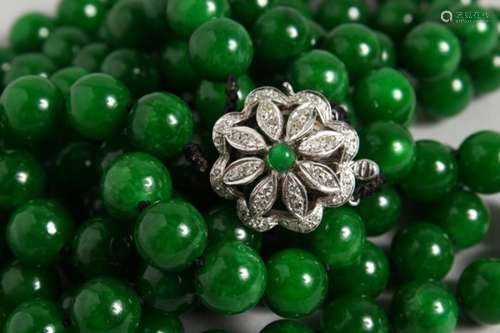 A GOOD DOUBLE ROW OF JADE BEADS, with 18ct white gold and diamond clasp. 25ins long.