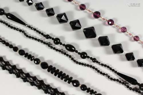 FIVE BLACK GLASS BEAD NECKLACES.