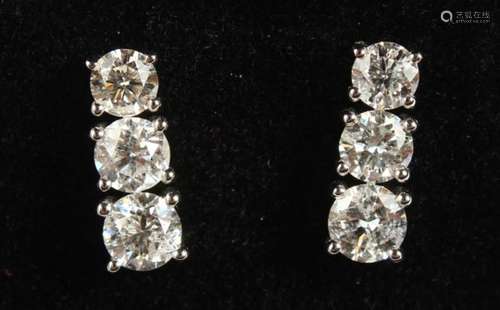 A GOOD PAIR OF 18CT WHITE GOLD THREE-STONE GRADUATED SET OF DIAMOND EARRINGS of 1.9CTS.