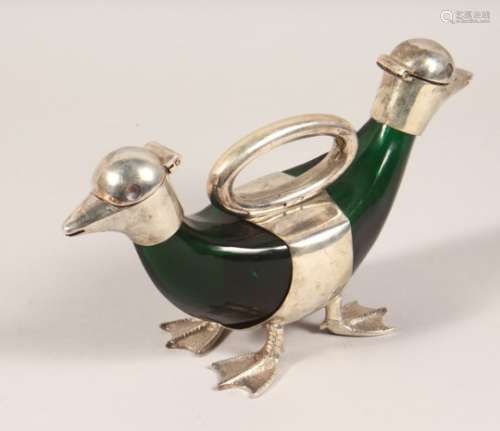 AN UNUSUAL PLATED AND GREEN GLASS DOUBLE ENDED DUCK SHAPE CLARET JUG. 10.5ins long.