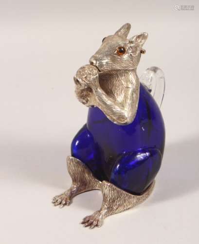 A NOVELTY PLATED AND BLUE GLASS CLARET JUG, modelled as a seated squirrel. 7ins high.