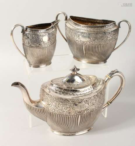 A THREE PIECE TEA SERVICE, comprising teapot, milk jug and sugar bowl, with fluted and embossed