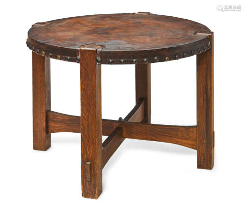 Library Tablecirca 1905oak, leather, metal nailheadsheight 28in (71.1cm); diameter 40in (101.6cm)  Gustav Stickley (1858-1942)