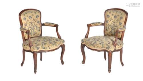 A pair of French stained beech and needlework upholstered armchairs