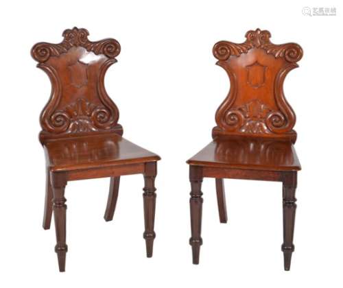 A pair of William IV mahogany hall chairs