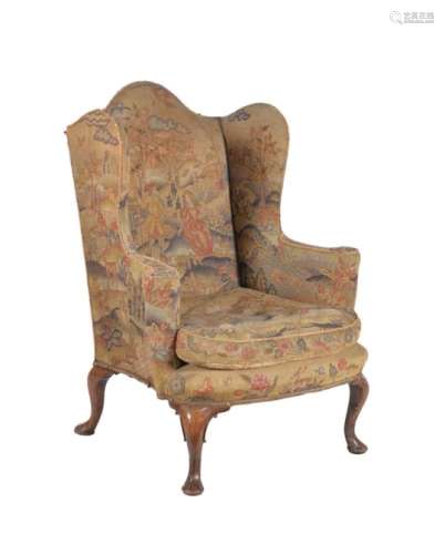 A walnut and upholstered wing armchair in Queen Anne style