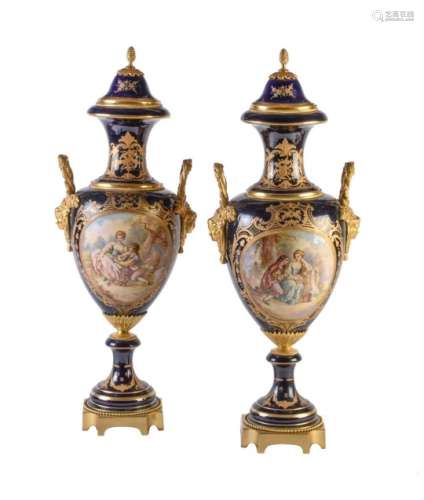 A pair of Limoges pottery Sevres-style blue-ground and gilt-metal-mounted vases and covers